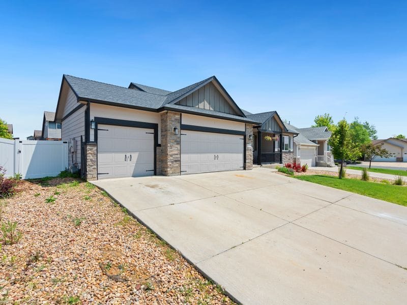 Front yard with a mulched strip along a concrete driveway