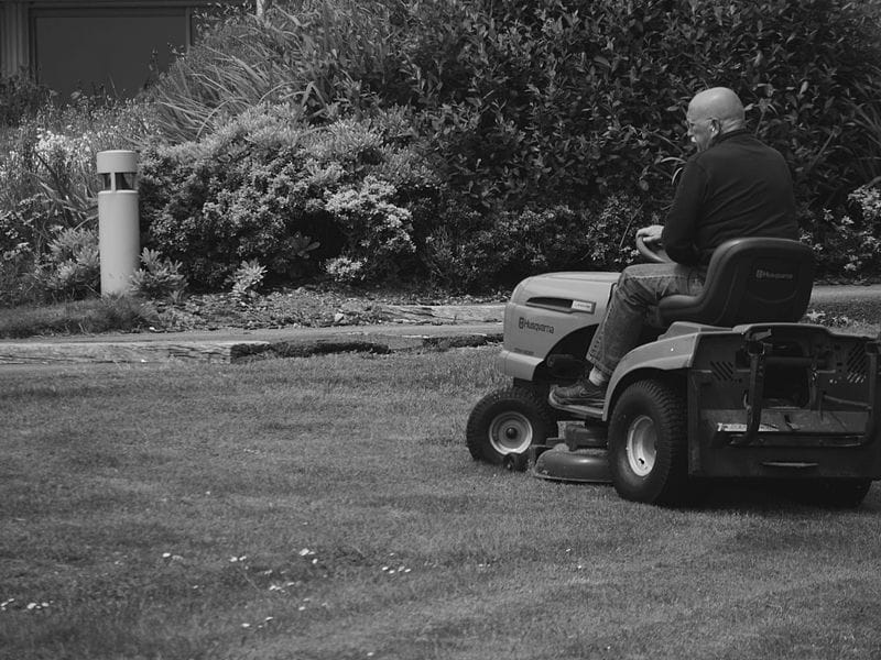 Man mowing a lawn on a riding mower